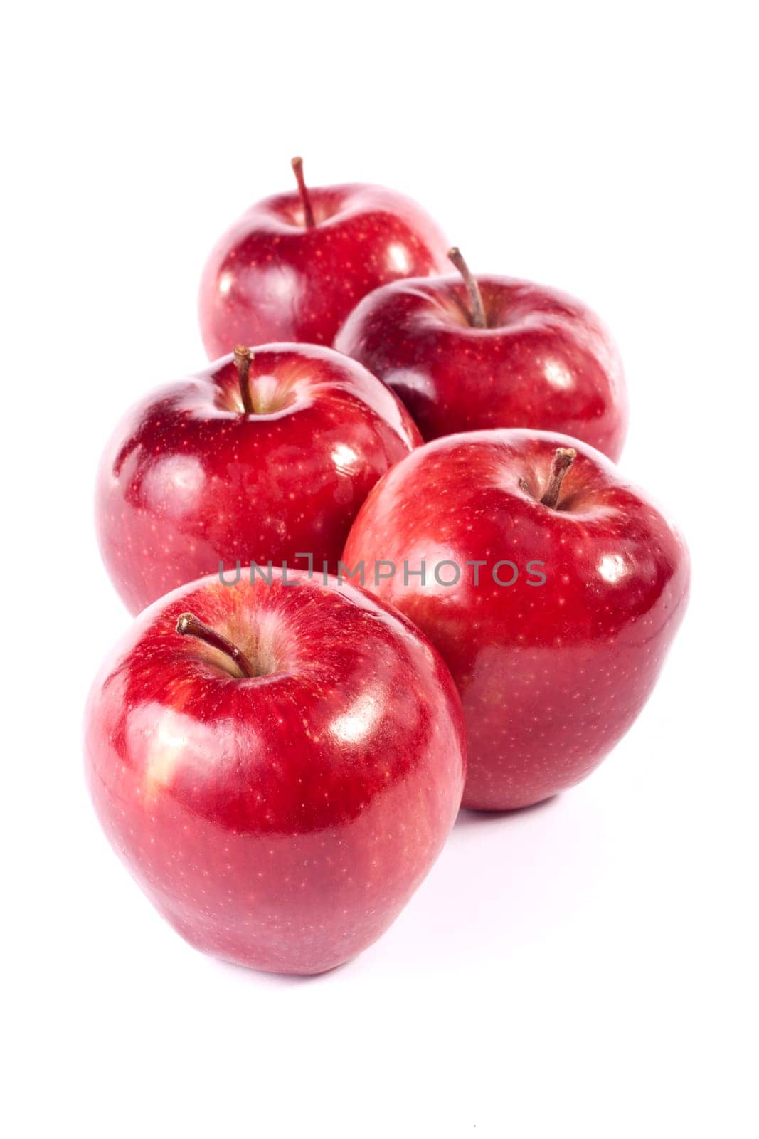 Close up view of some red apples isolated on a white background.