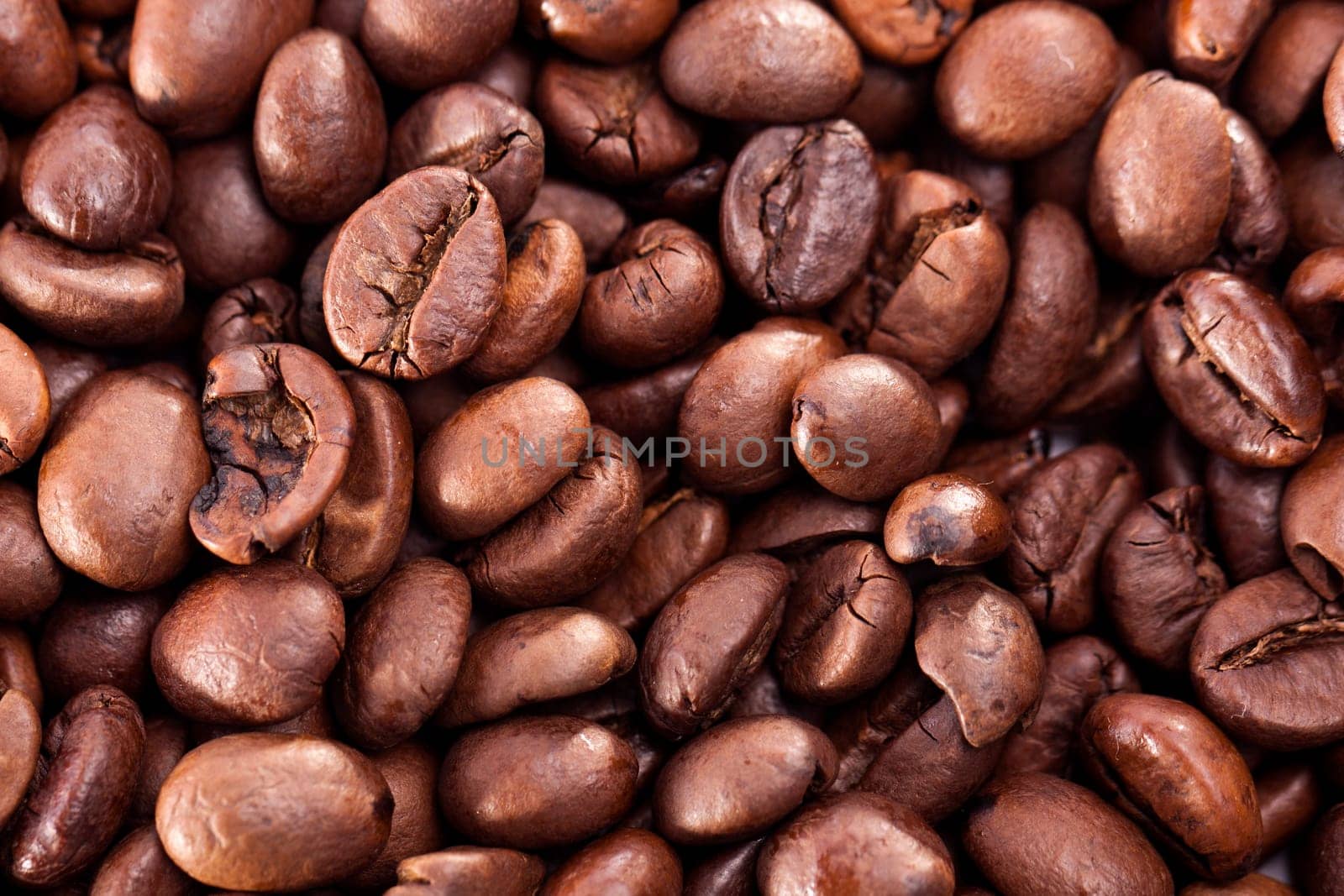 Close up view of a bunch of roasted beans of coffee.