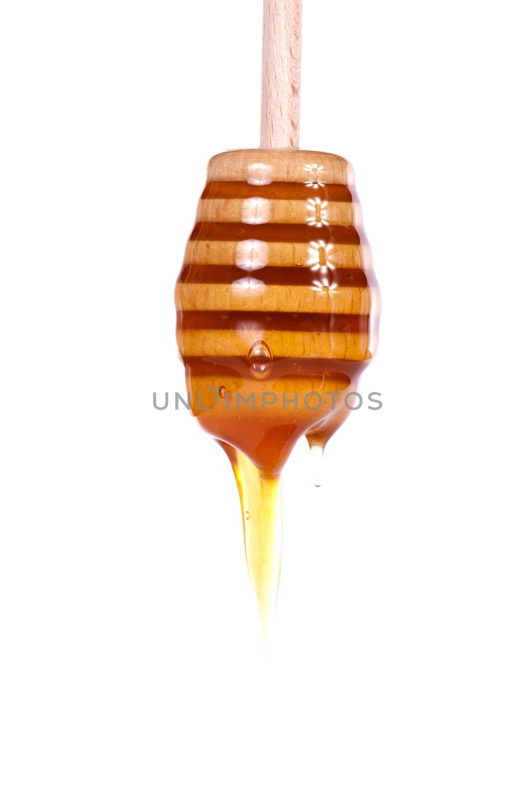 Close up view of a glass of honey and another of chocolate with cookie rolls.