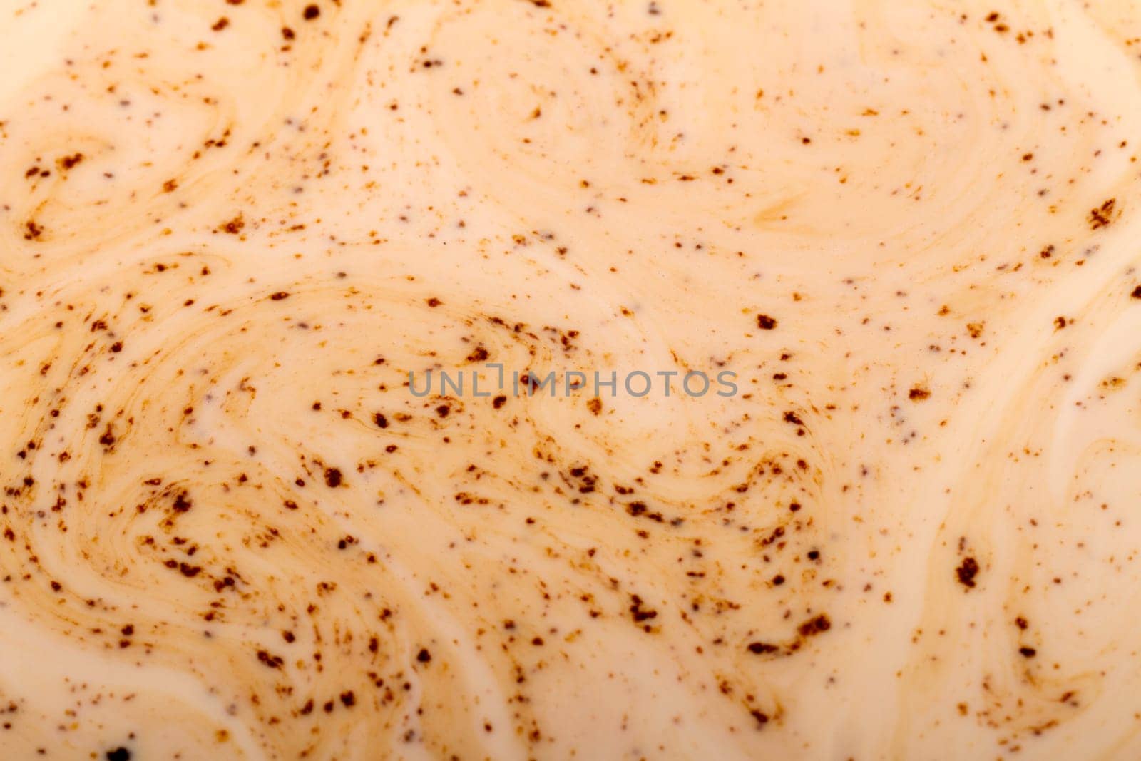 Close up view detail of the texture of coffee mixed with milk.