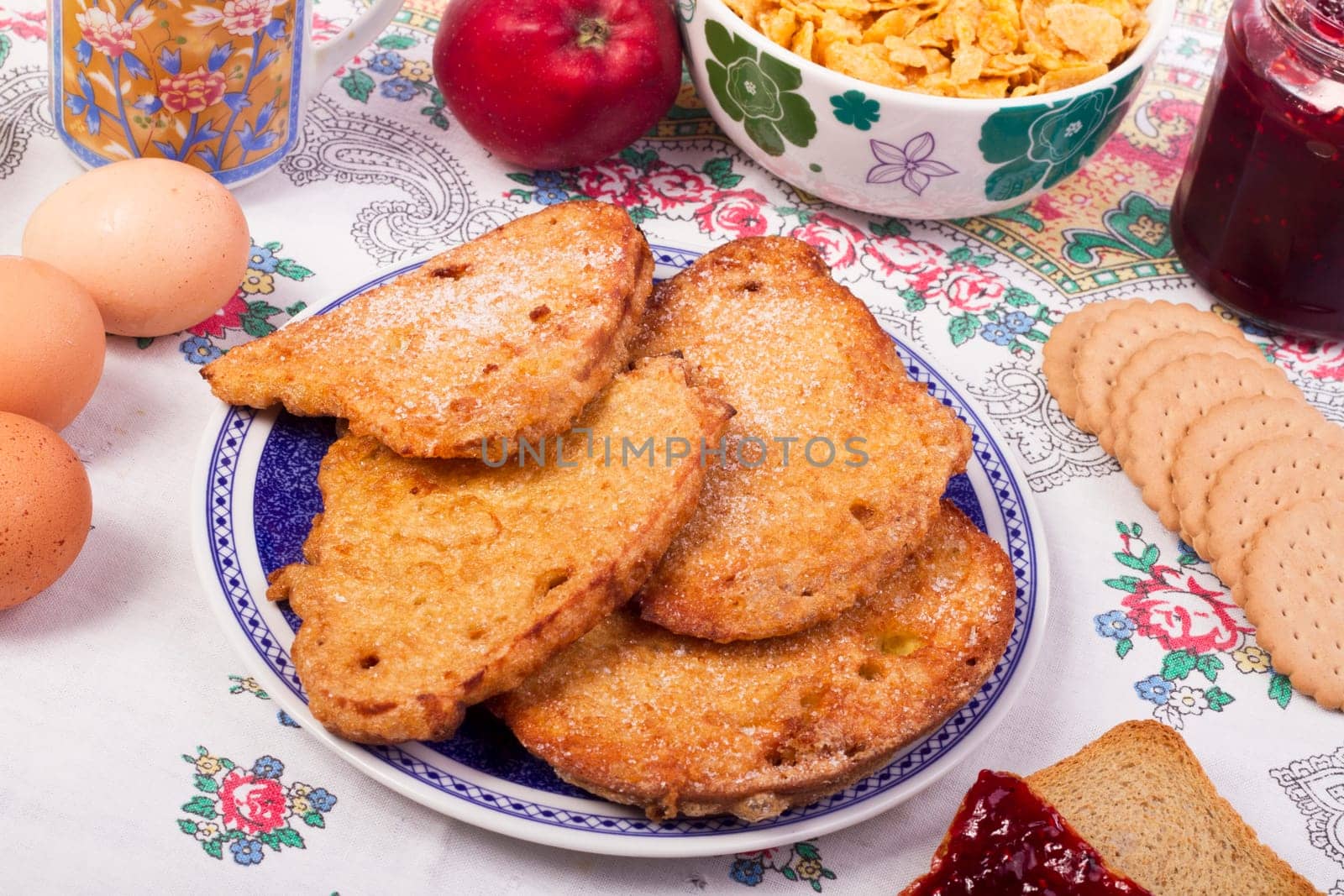 Close up view detail of several golden slices of bread sprinkled with sugar.
