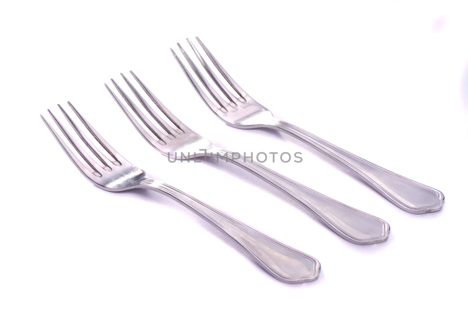 Close up view detail of some forks isolated on a white background.