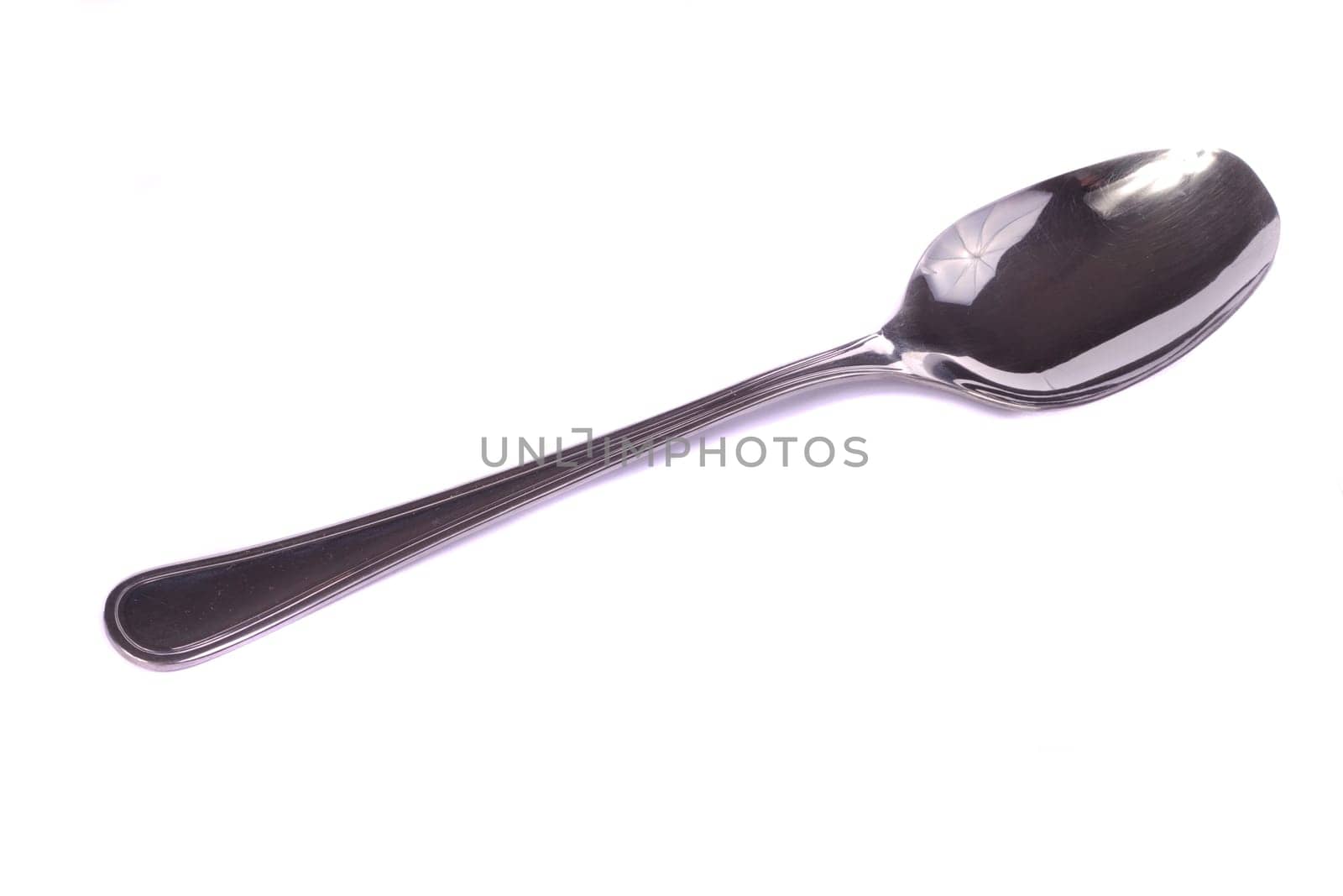 Close up view detail of a spoon isolated on a white background.