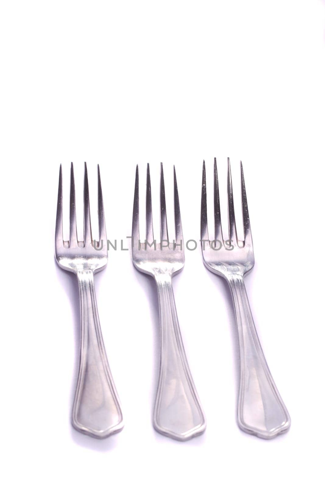 Close up view detail of some forks isolated on a white background.