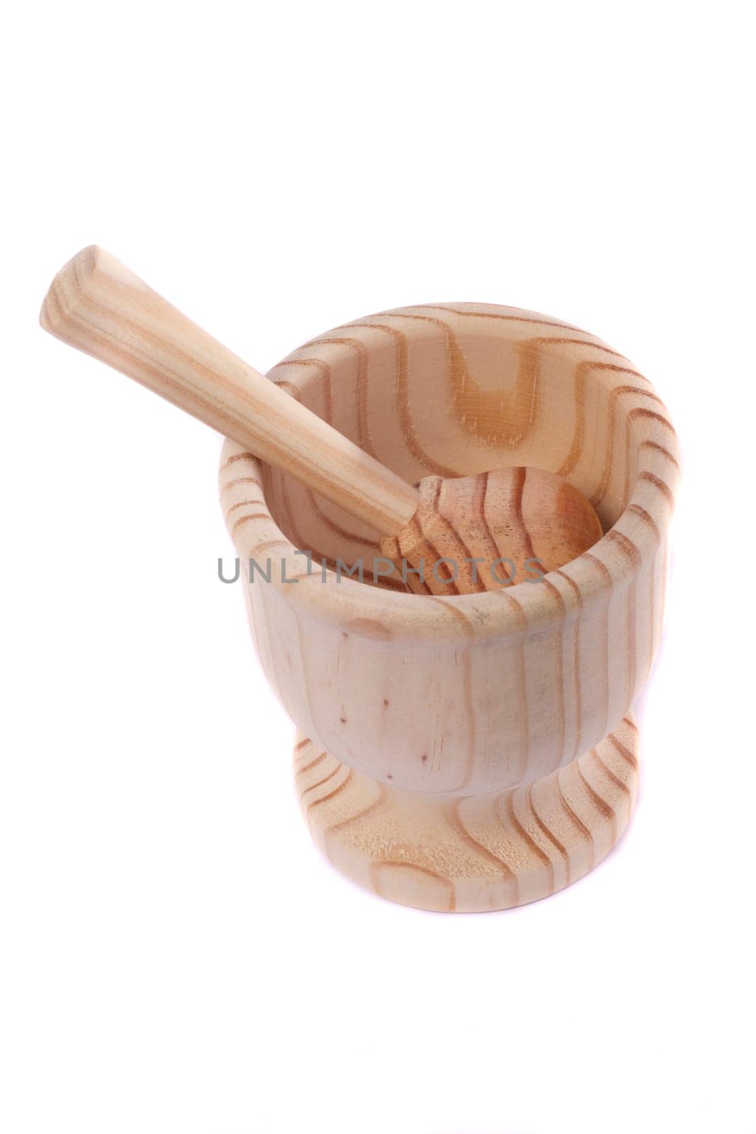 Close up view detail of a wooden garlic smasher isolated on a white background.