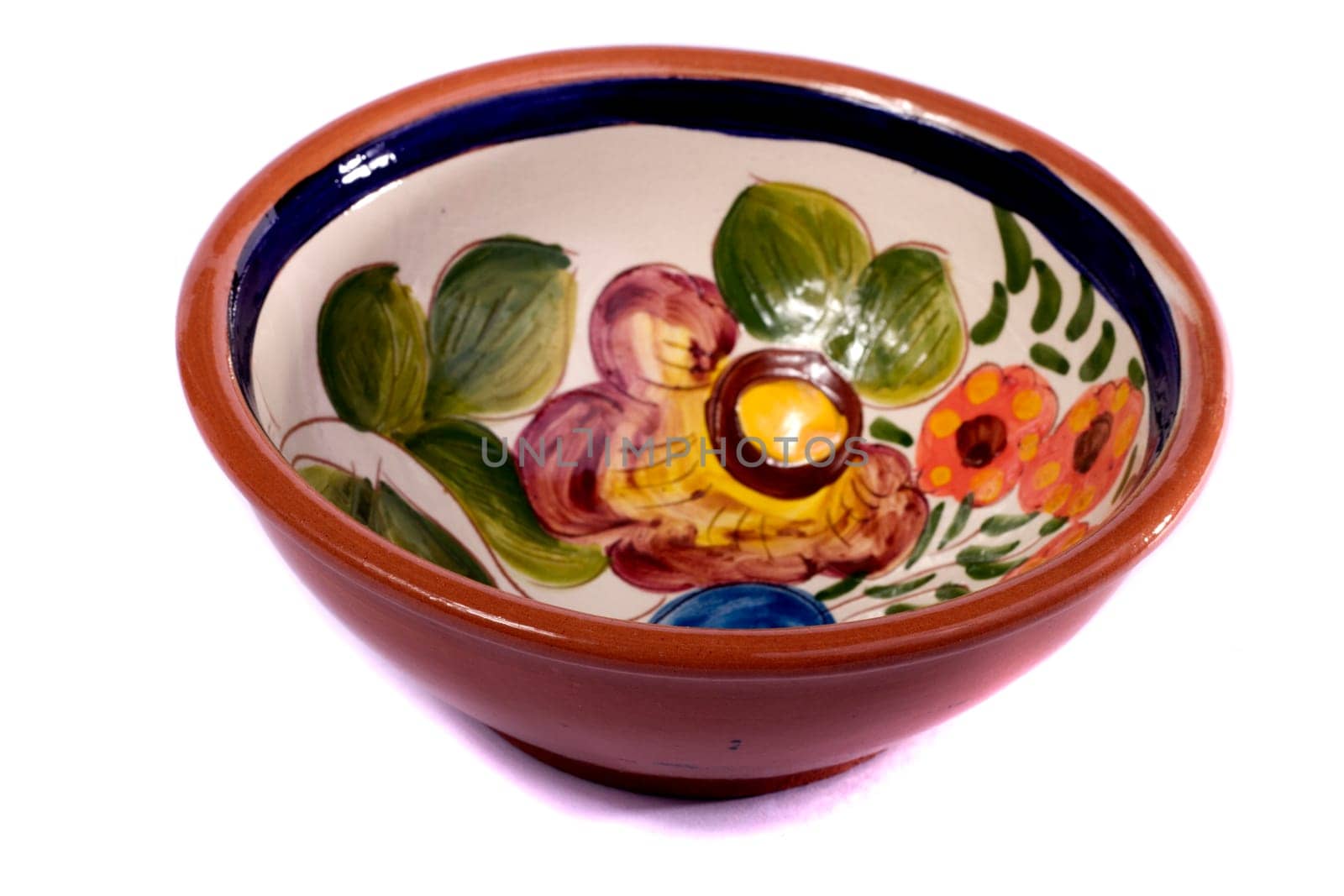 Close up view detail of a earthenware soup bowl isolated on a white background.