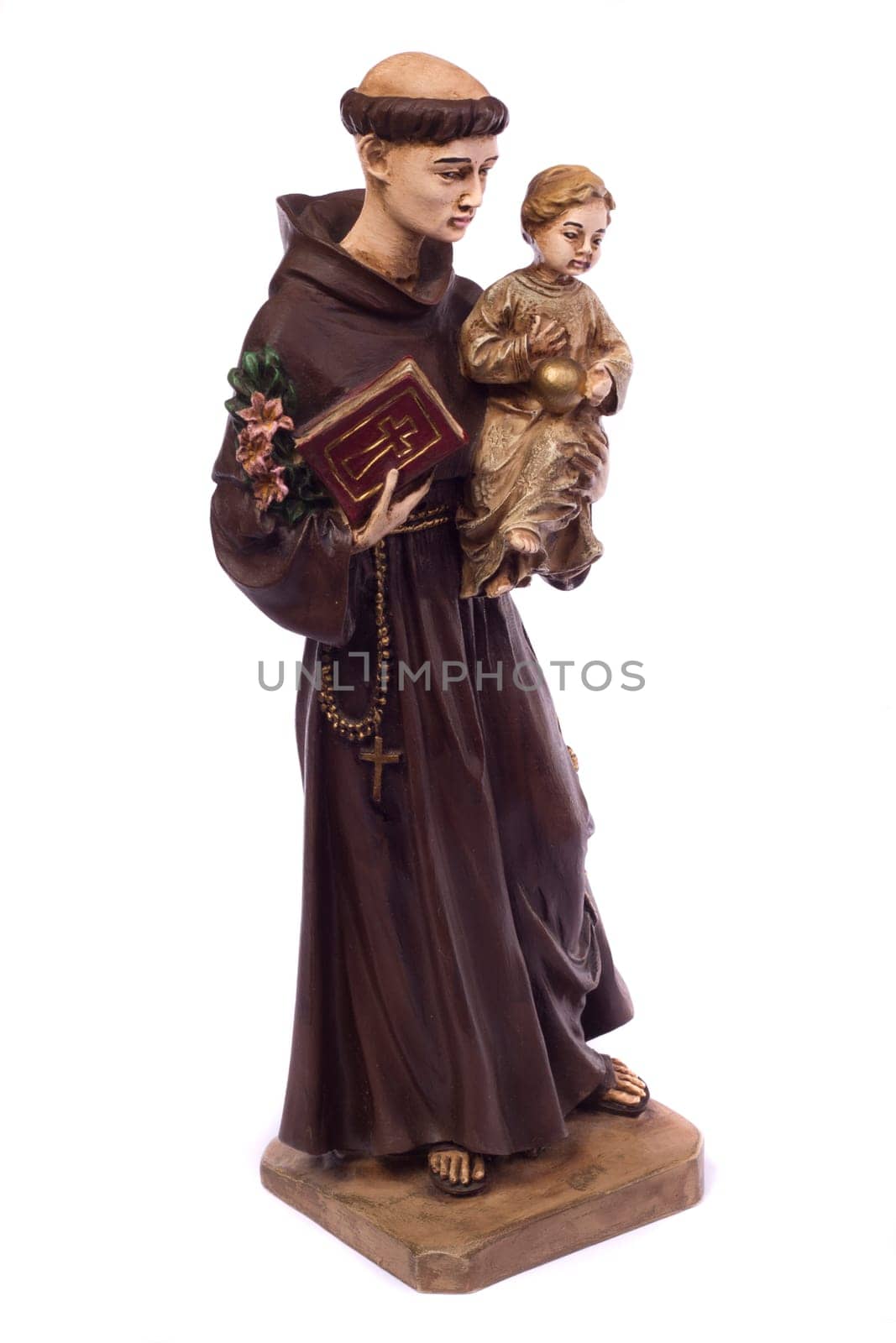 Close up view detail of a ceramic monk holding a child, isolated on a white background.