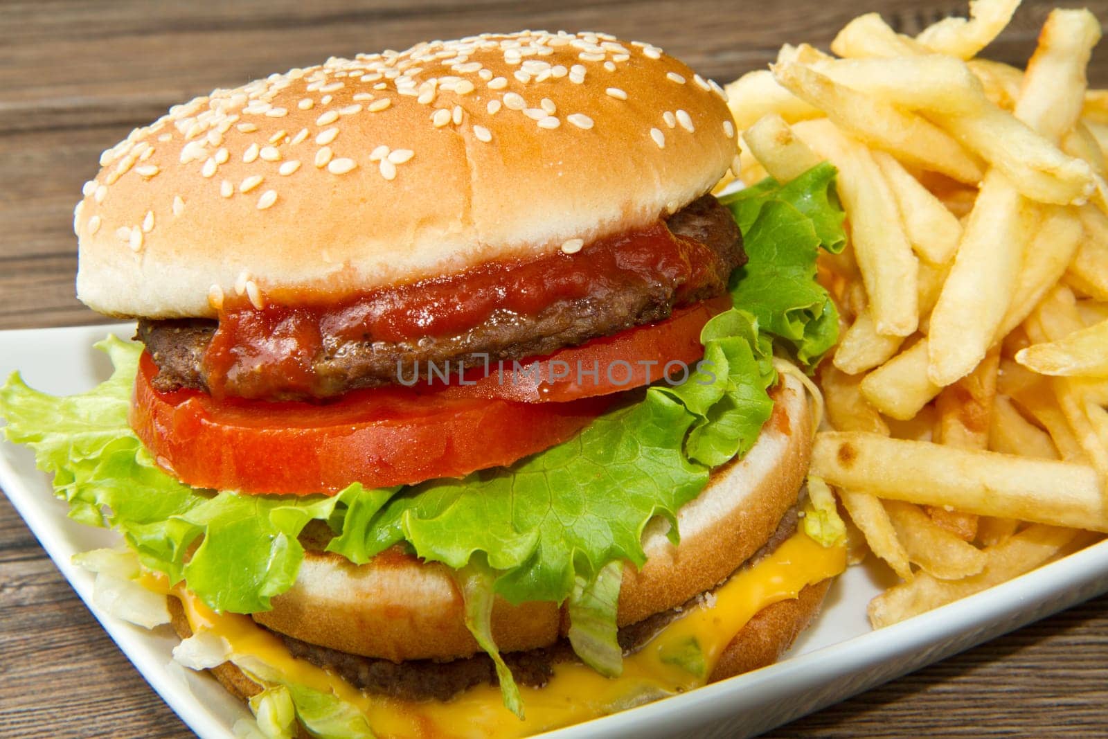 hamburger with potatoes on wooden background
