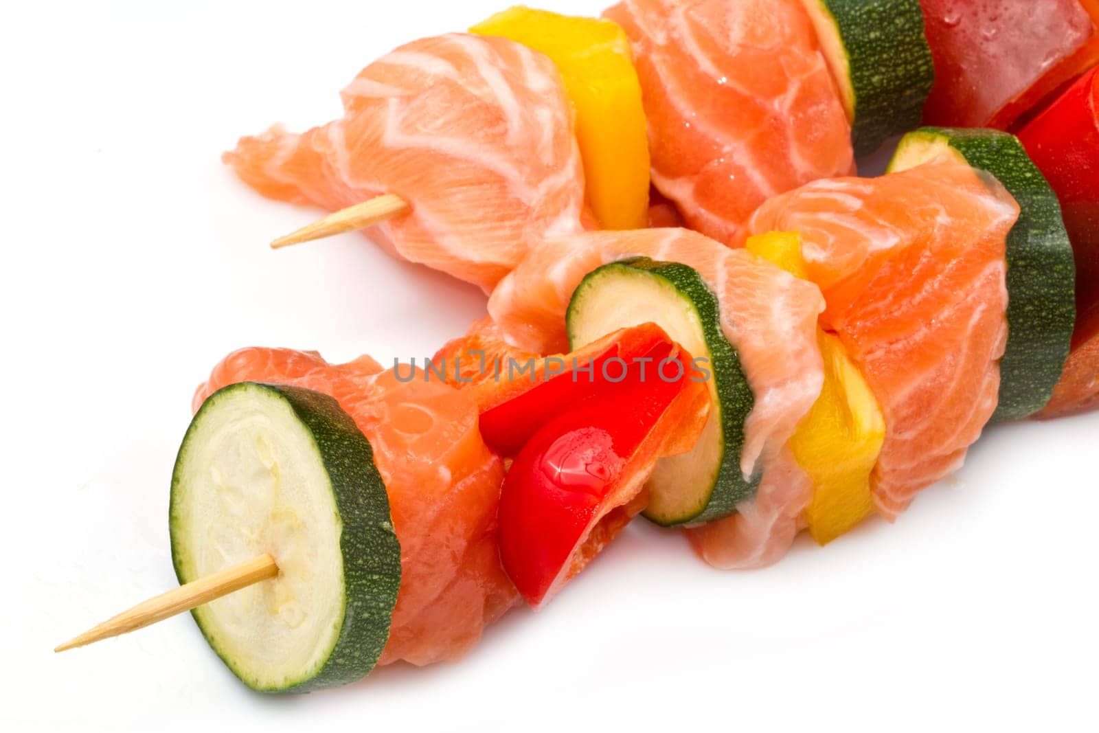 salmon kebab with zucchini and peppers isolated on white background