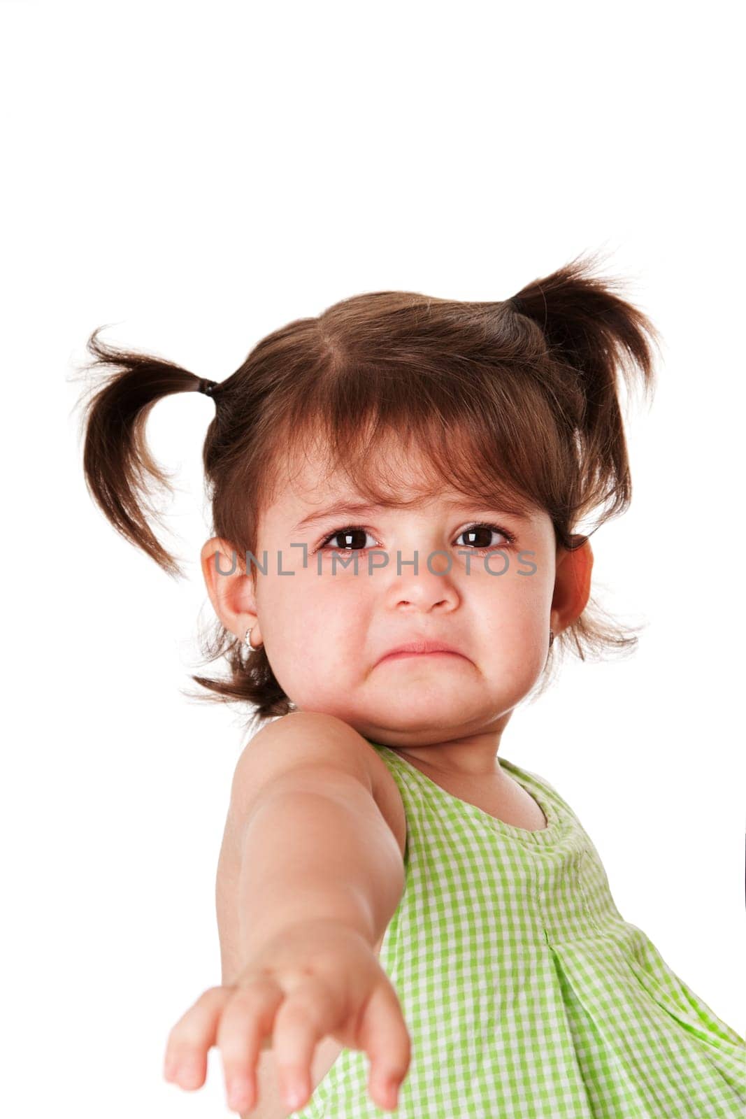 Cute baby toddler young little girl with very sad face expression reaching out for help, isolated.