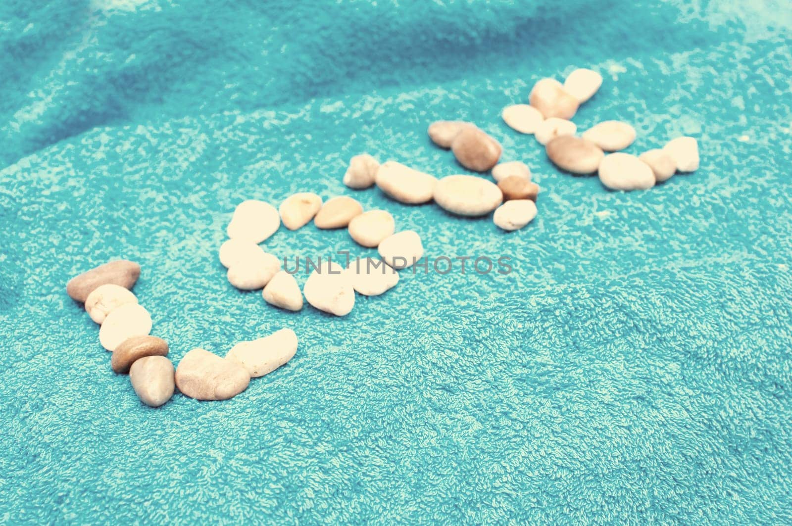 Love Sign Made of Pebbles on Blue Towel - Vintage Look