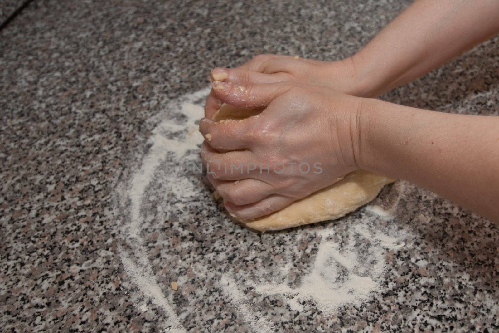 Two hands kneading a dough