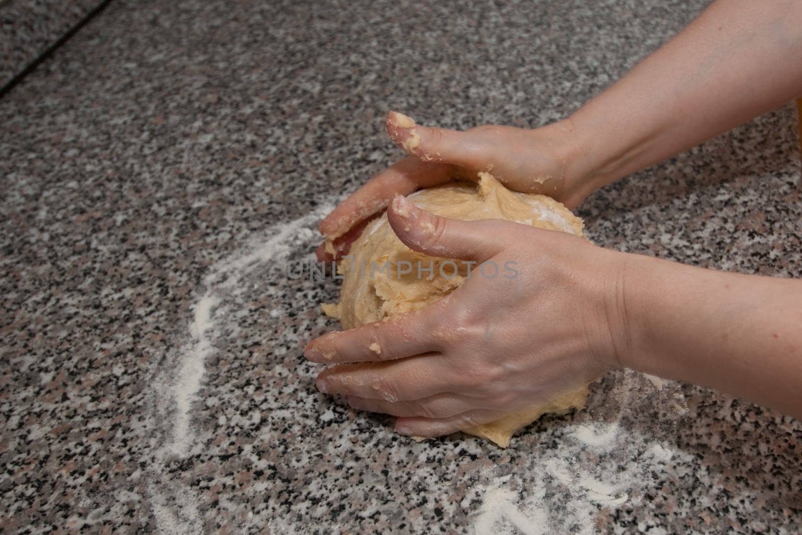 Two hands kneading a yeast dough
