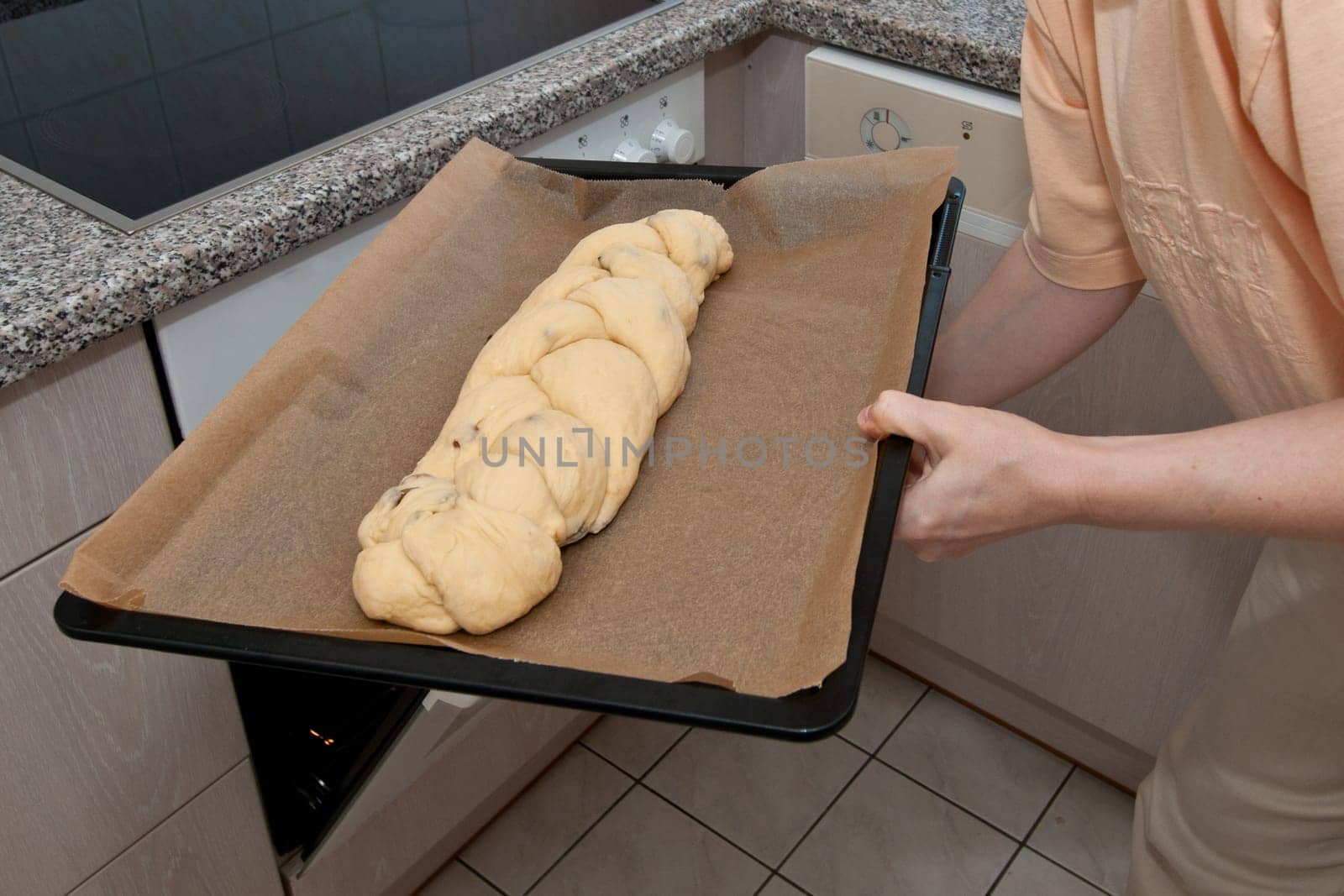Raw yeast braid is pushed into the oven