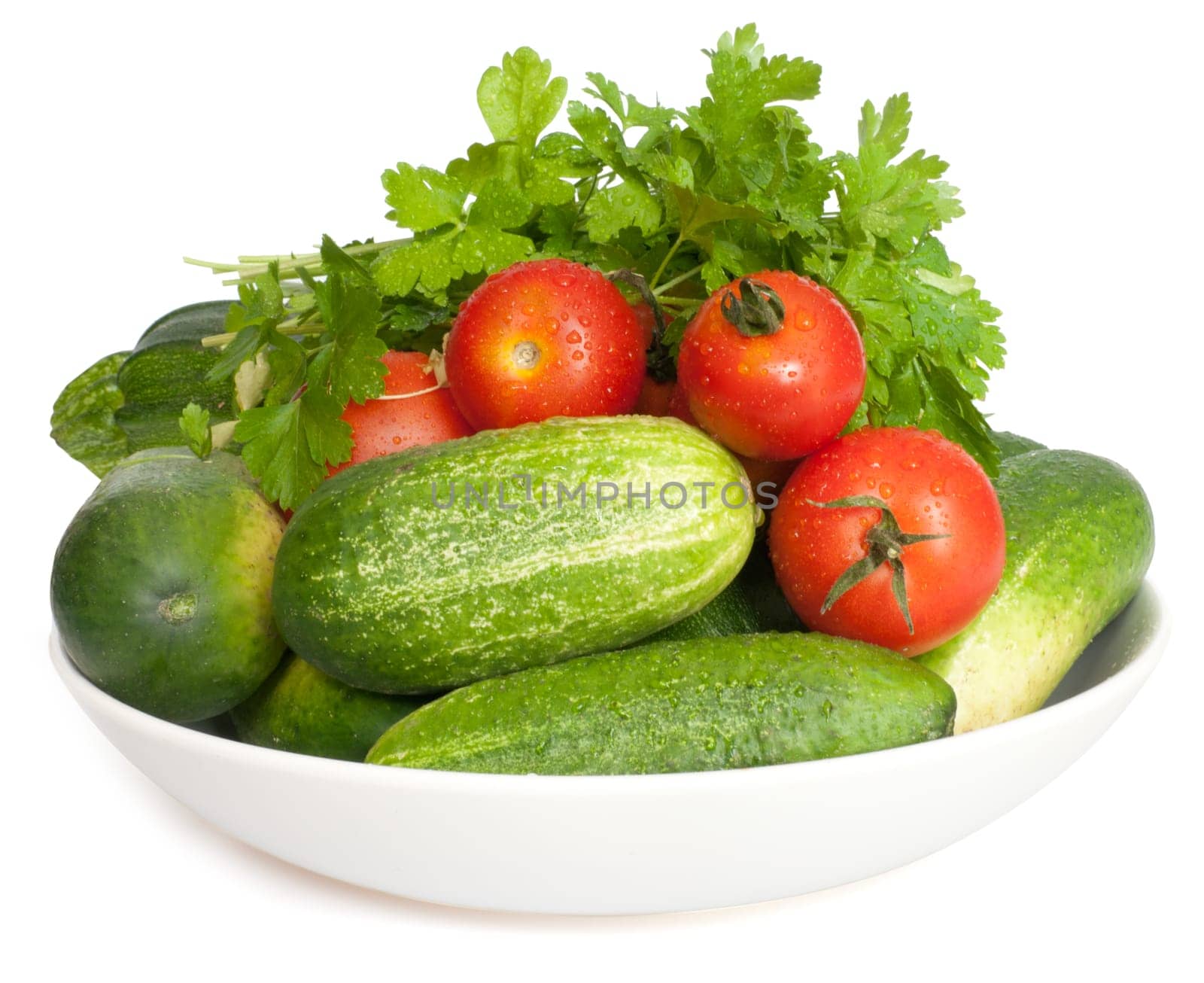 Fresh Vegetables on Plate on White Background - Tomatoes, Cucumbers, Zucchinis and Parsley