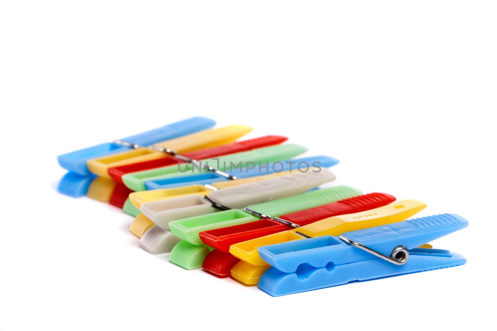 Close up view of some colorful cloth pegs isolated on a white background.