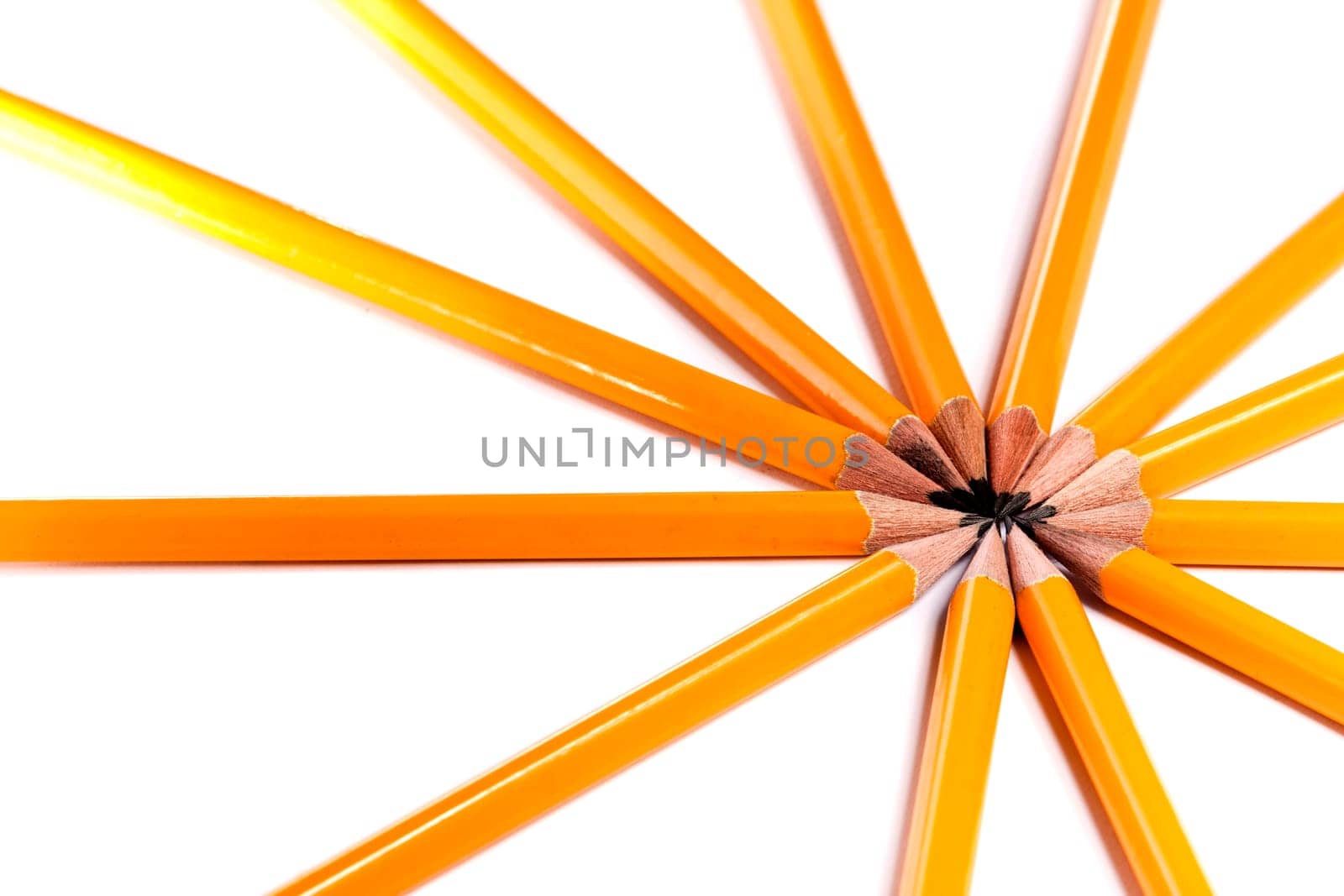 Close up view of a bunch of yellow pencils isolated on a white background.