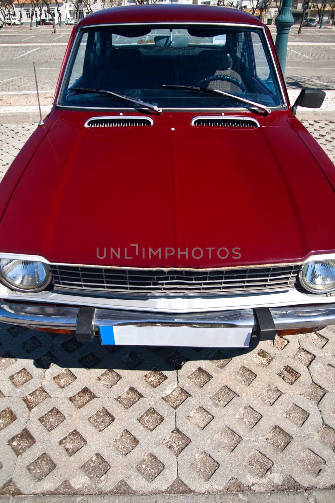 Close view of a classic car from the seventies parked on a park.
