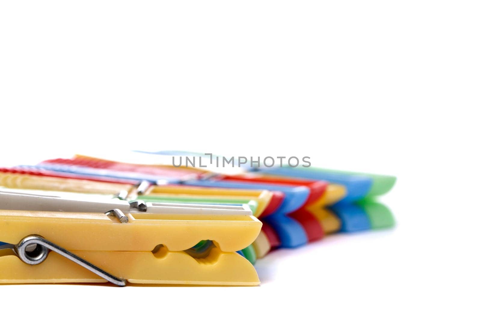 Close up view of some colorful cloth pegs isolated on a white background.