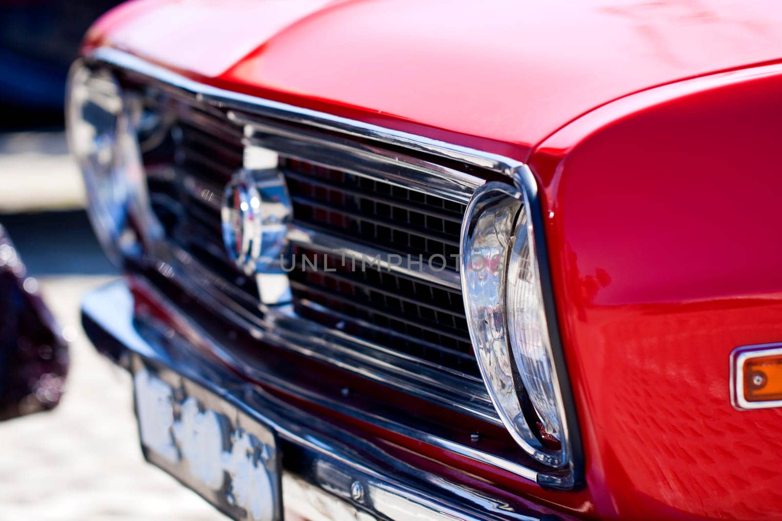 Close view of a classic car from the seventies parked on a park.