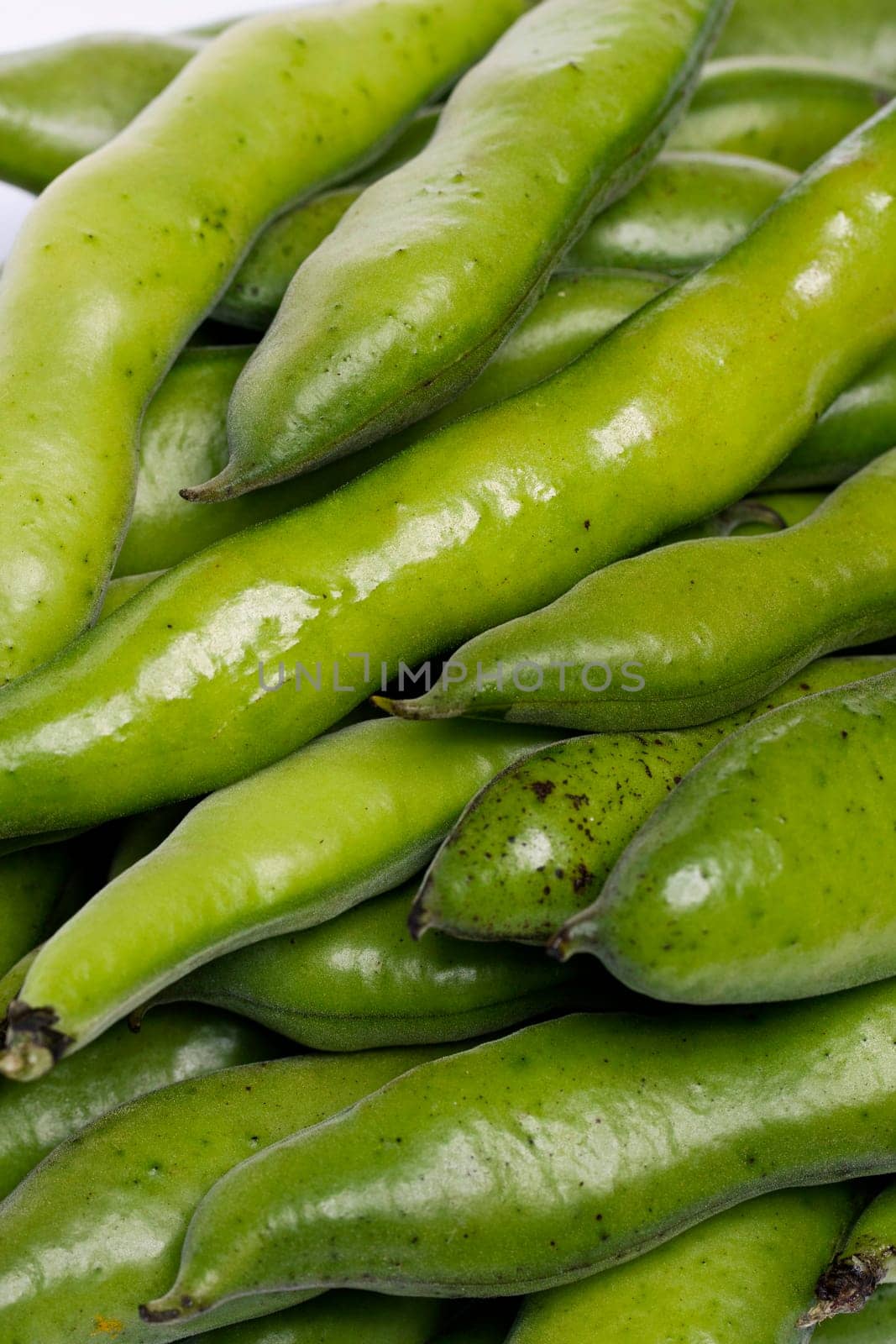 Close up view of some broad beans isolated on a white background.