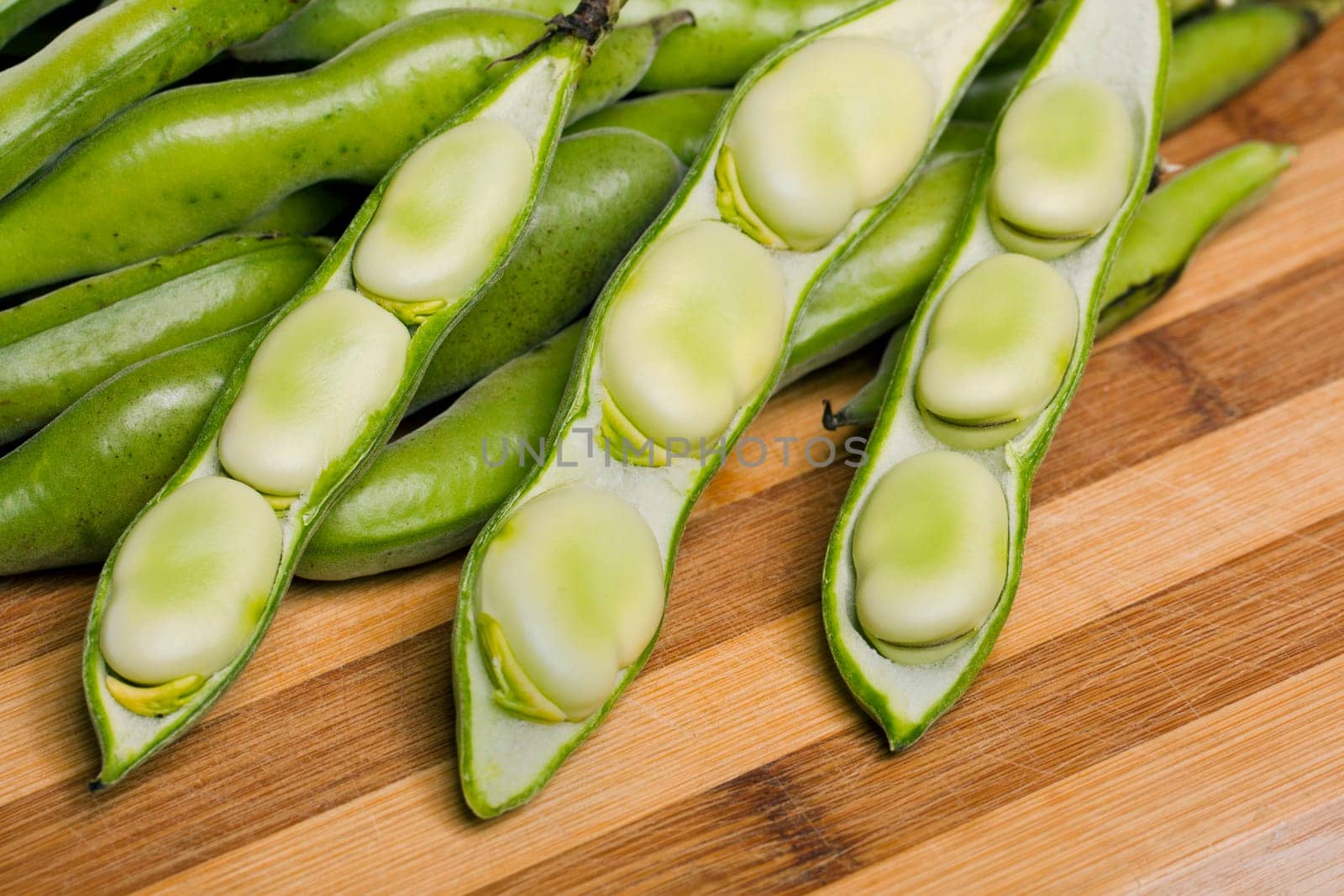 Close up view of some broad beans isolated on a white background.