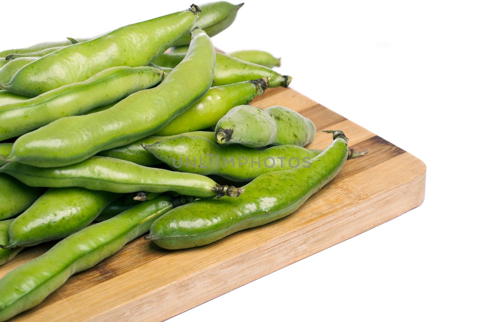 Close up view of some broad beans isolated on a white background.