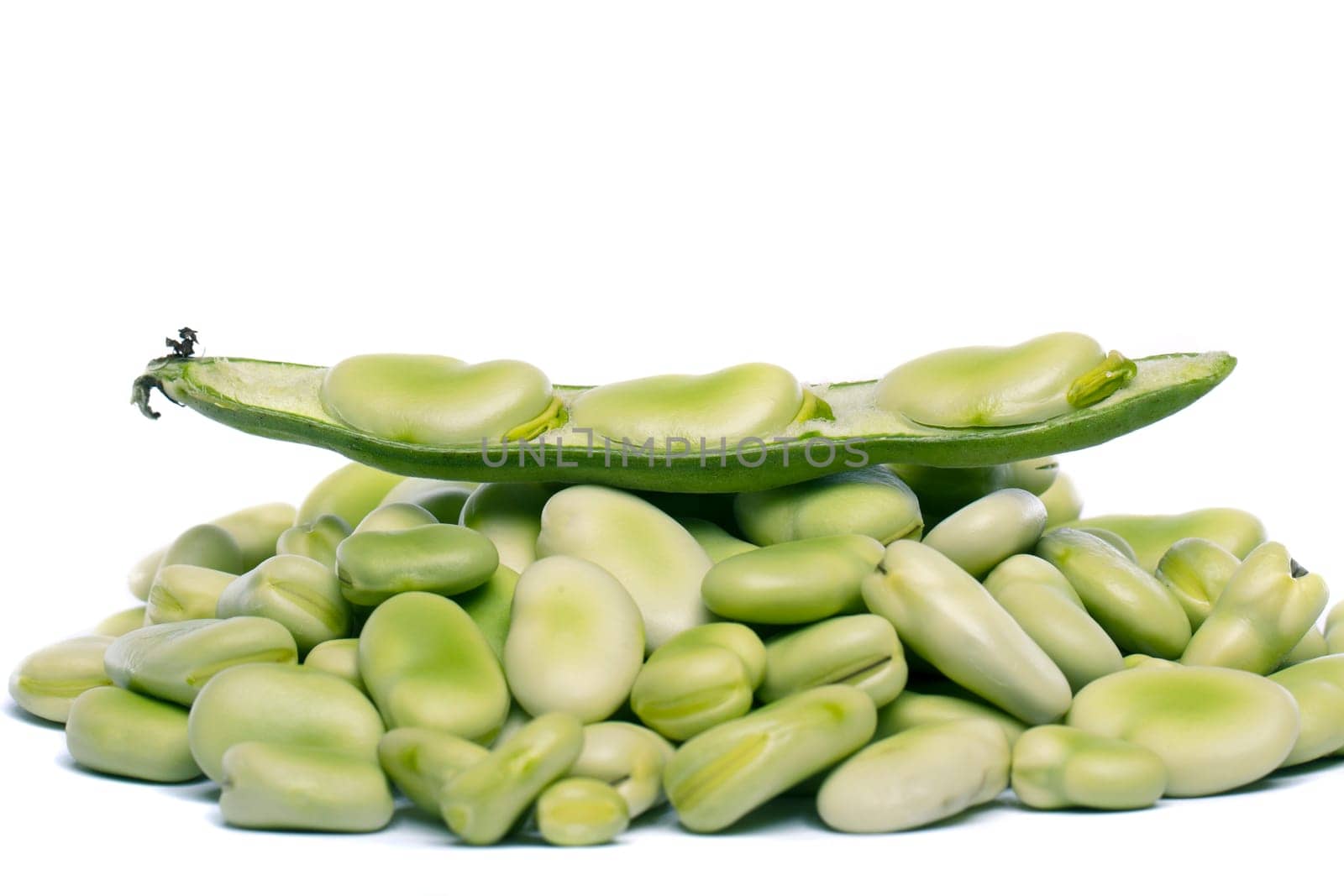 Close up view of some broad beans isolated on a white background.