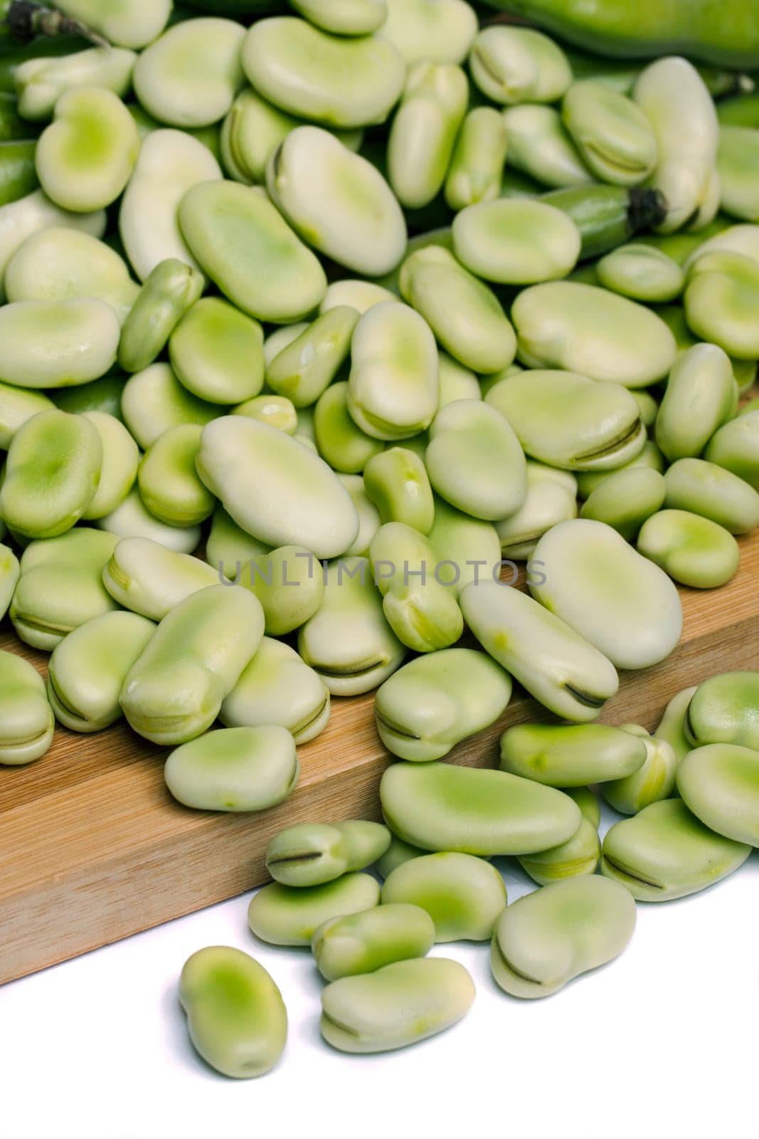 Close up view of some broad beans isolated on a white background.