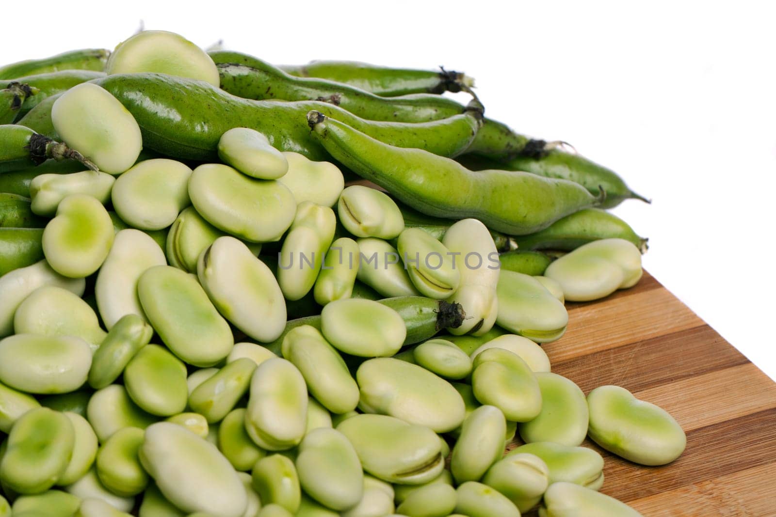 Close up view of some broad beans isolated on a white background.