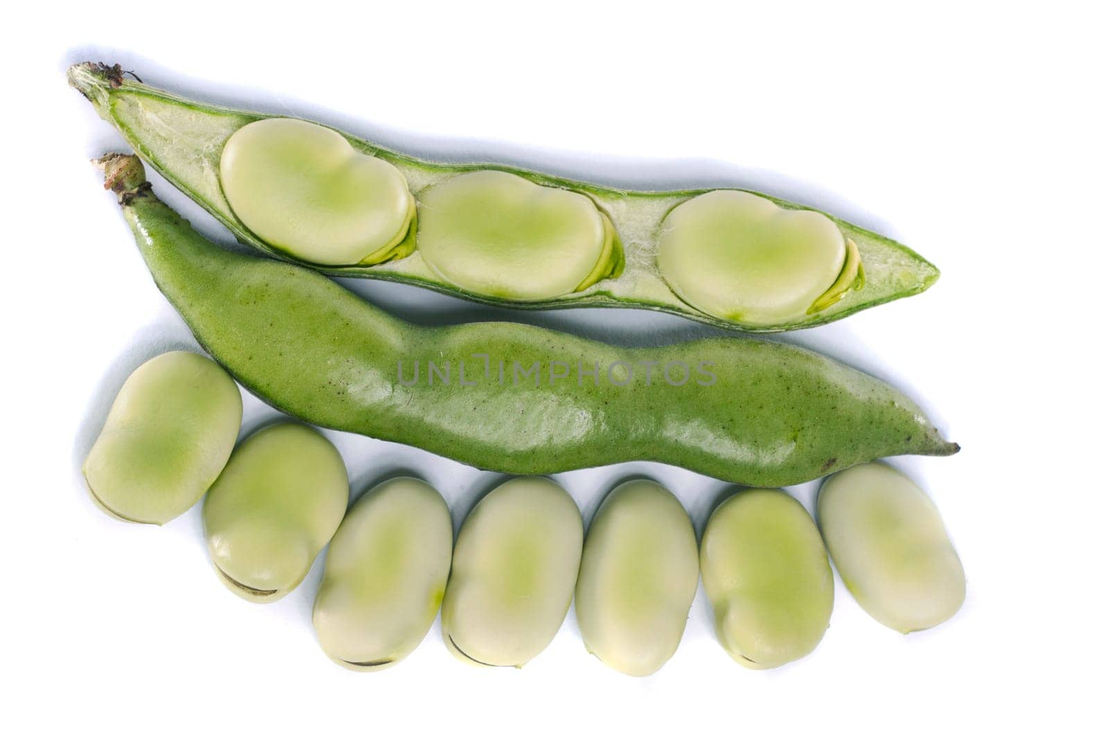 Close up view of some broad beans isolated on a white background.