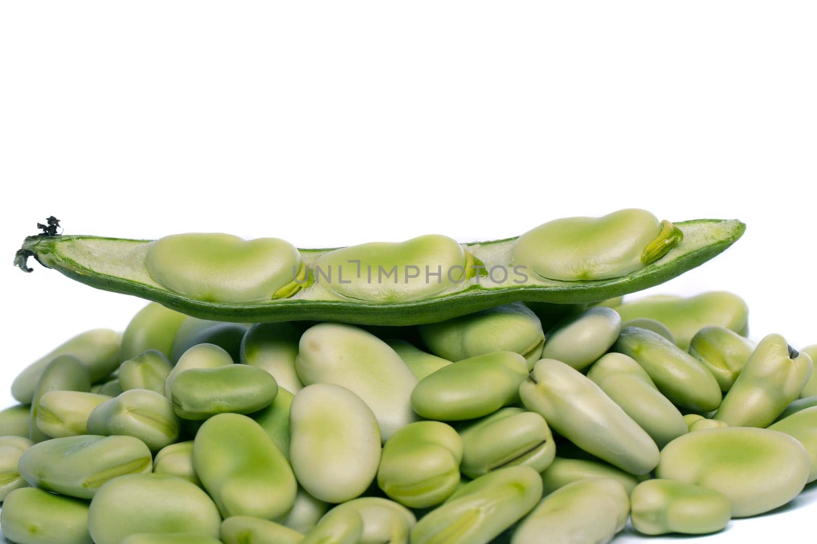 Close up view of some broad beans isolated on a white background.