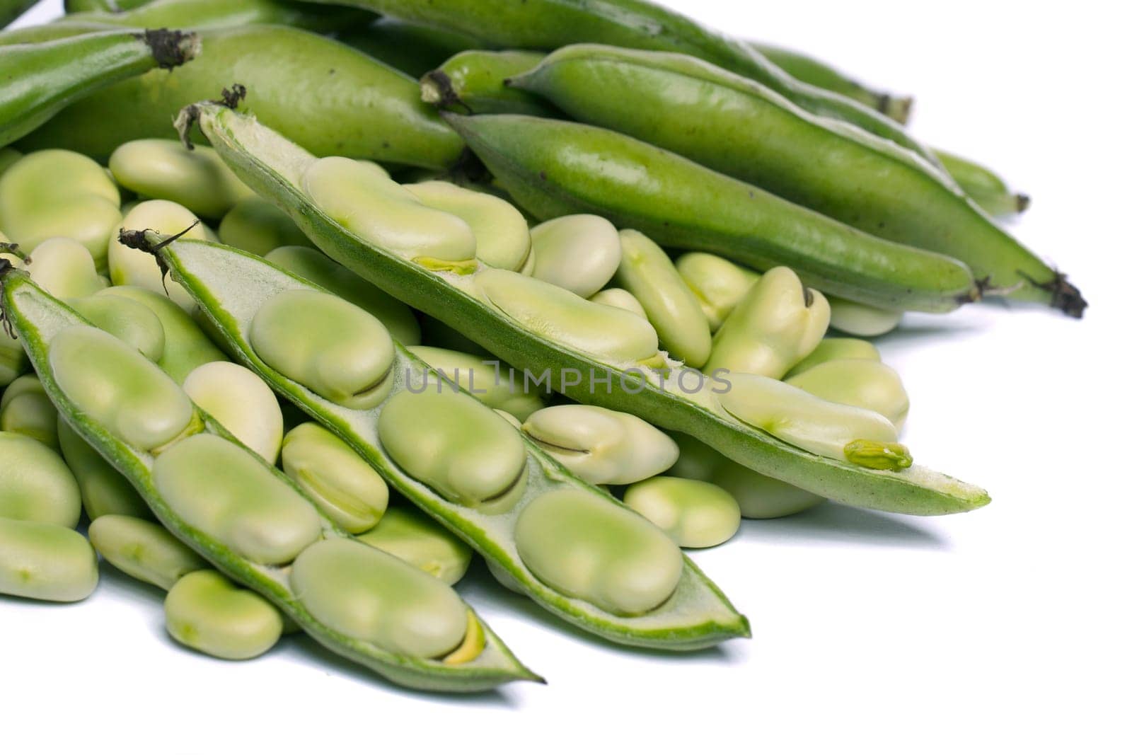 Close up view of some broad beans isolated on a white background.