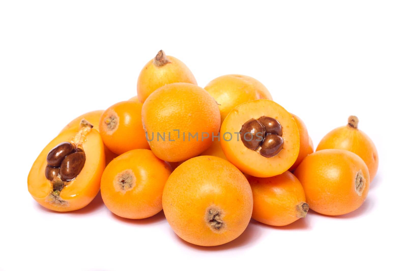 Close up view of some loquat fruit isolated on a white background.