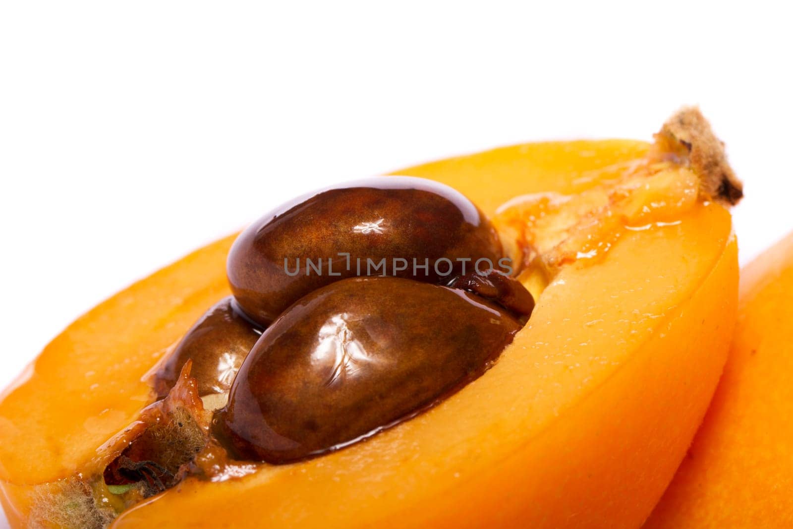 Close up view of some loquat fruit isolated on a white background.