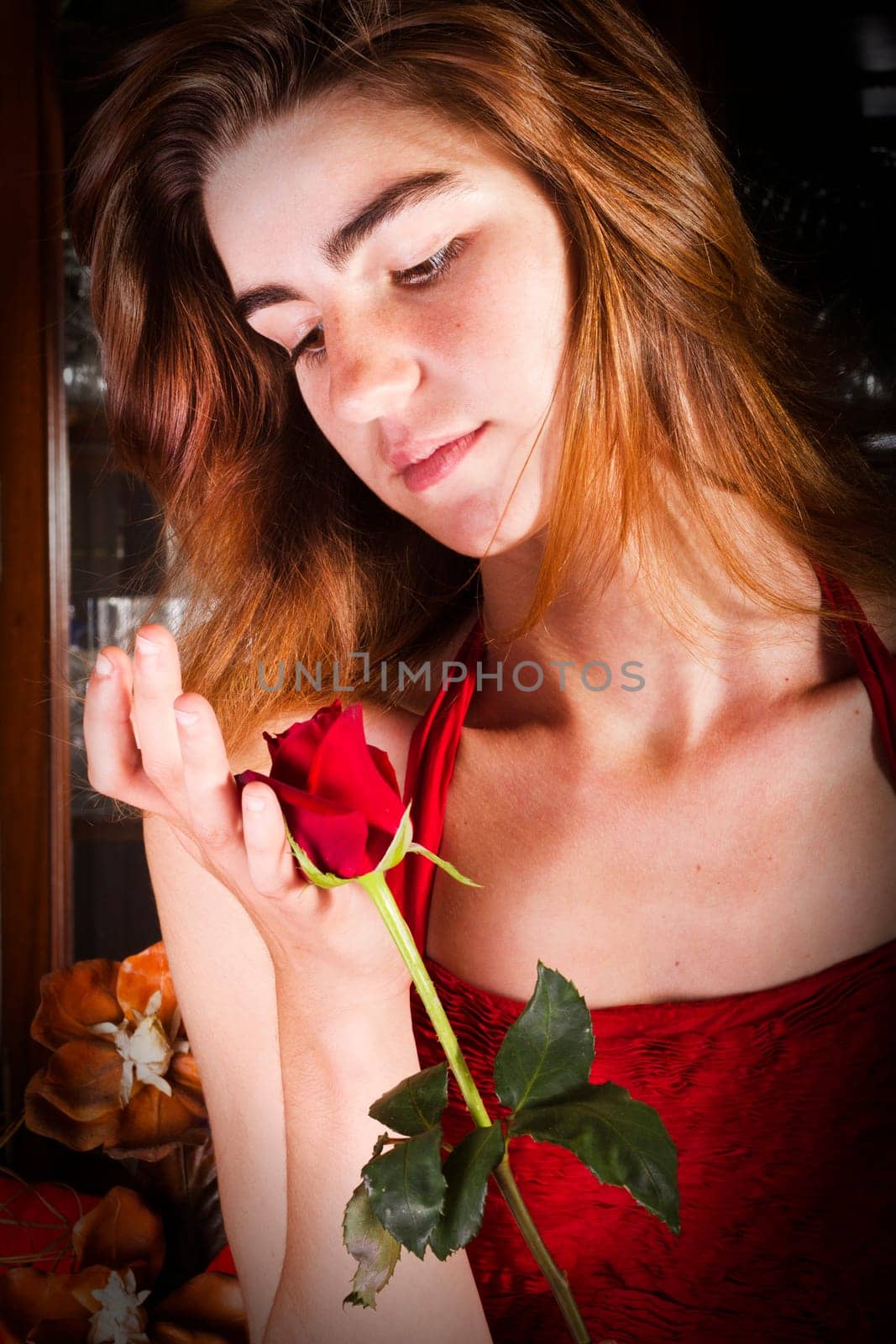 View of a beautiful young girl in a red dress on a living room.