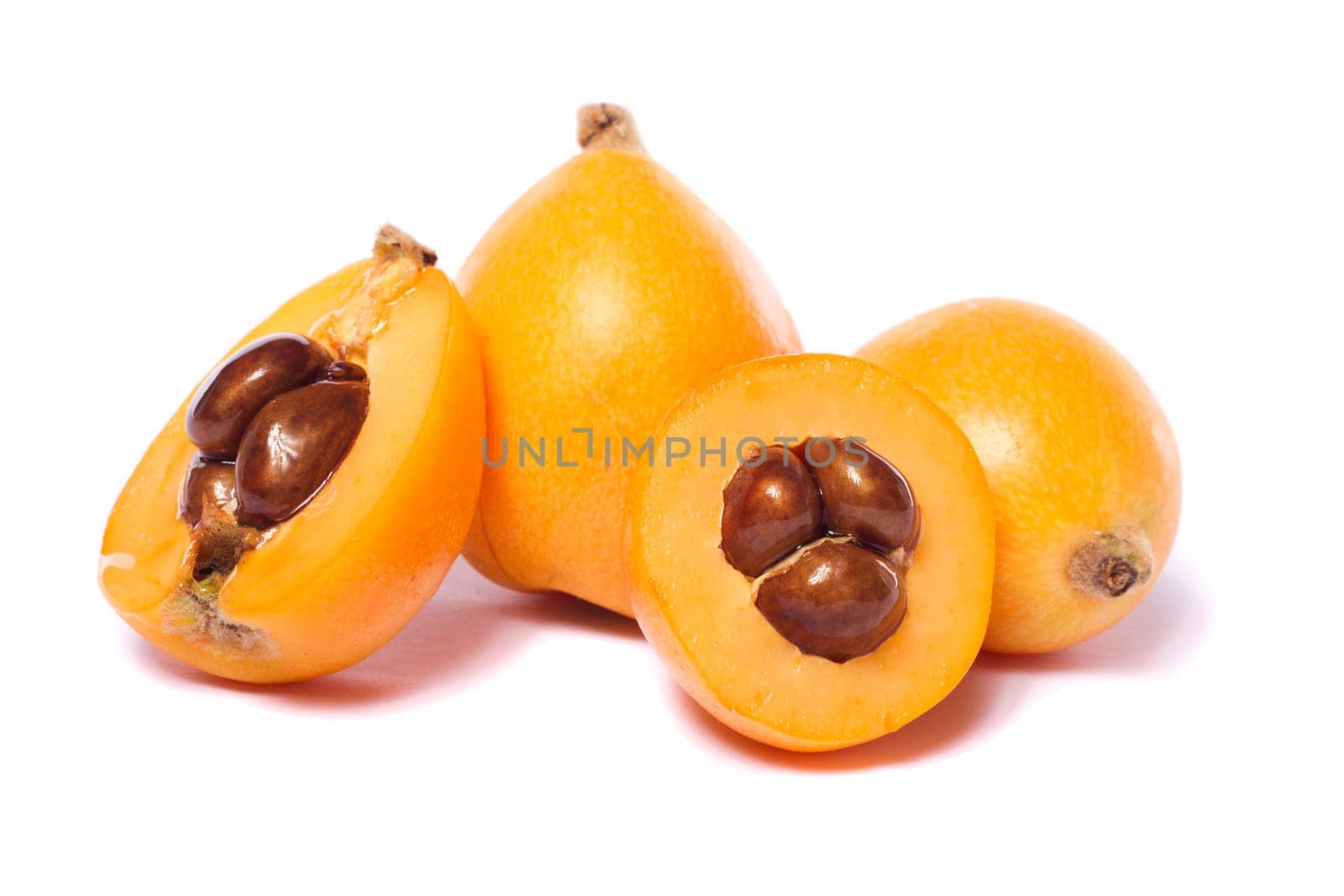 Close up view of some loquat fruit isolated on a white background.