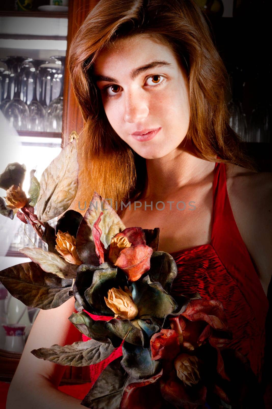 View of a beautiful young girl in a red dress on a living room.