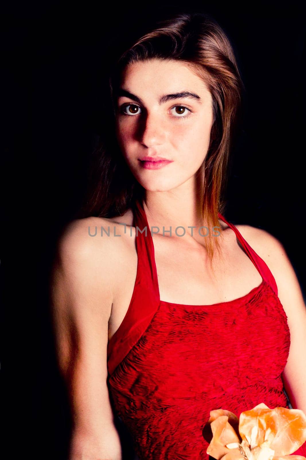 View of a beautiful young girl in a red dress on a living room.