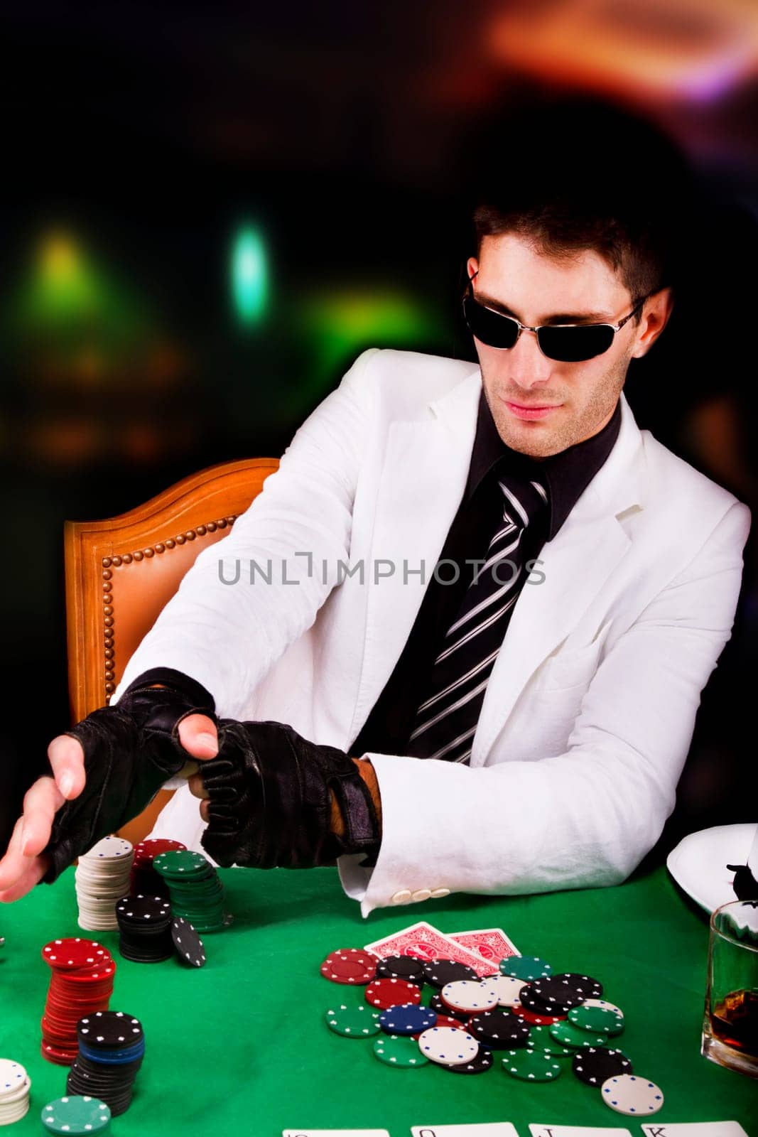 View of a gangster man playing some cards and poker.