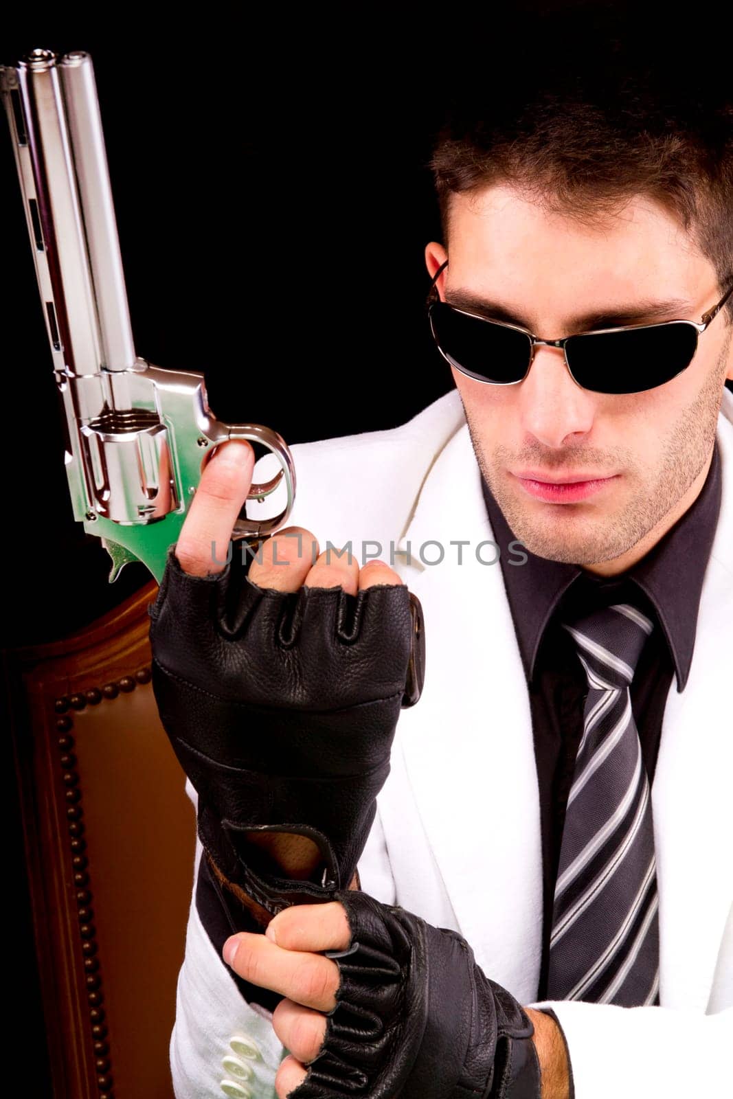 View of a white suit gangster man holding a gun.