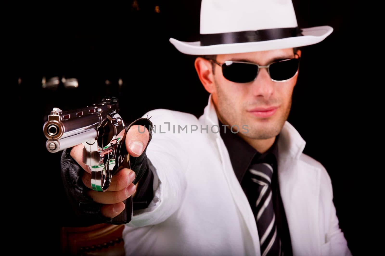 View of a white suit gangster man holding a gun.