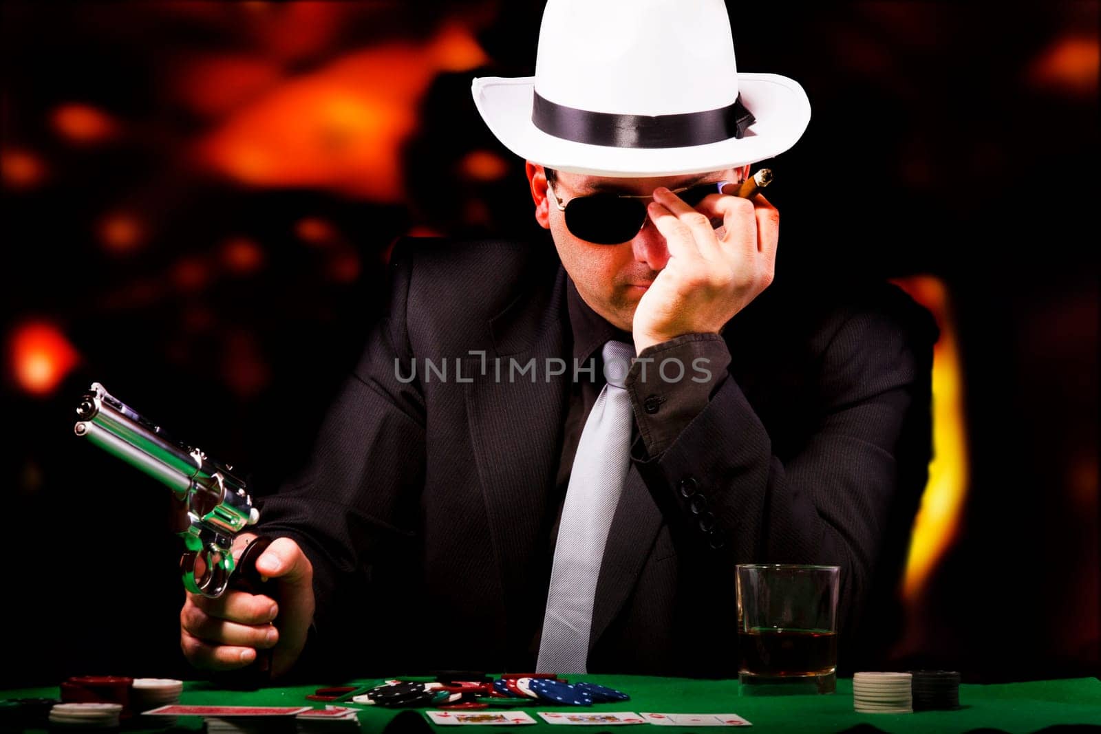 View of a gangster man playing some cards and poker.