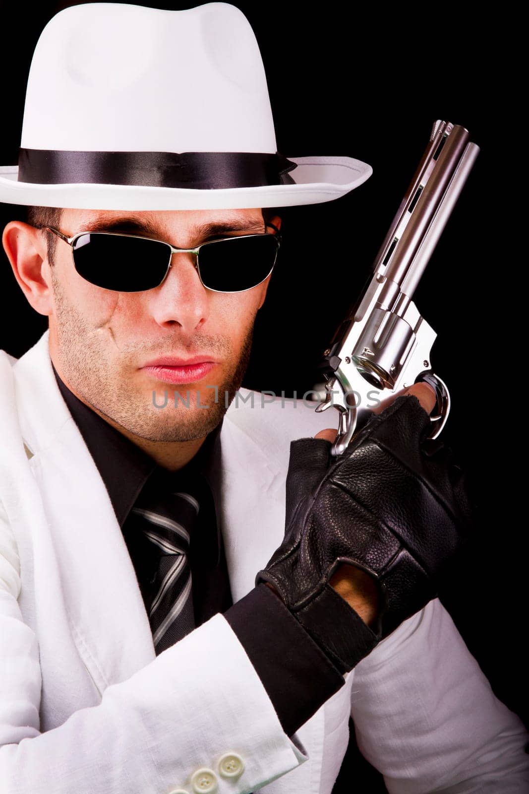 View of a white suit gangster man holding a gun.