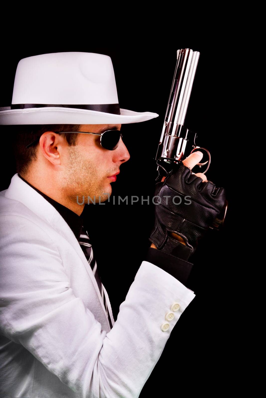 View of a white suit gangster man holding a gun.