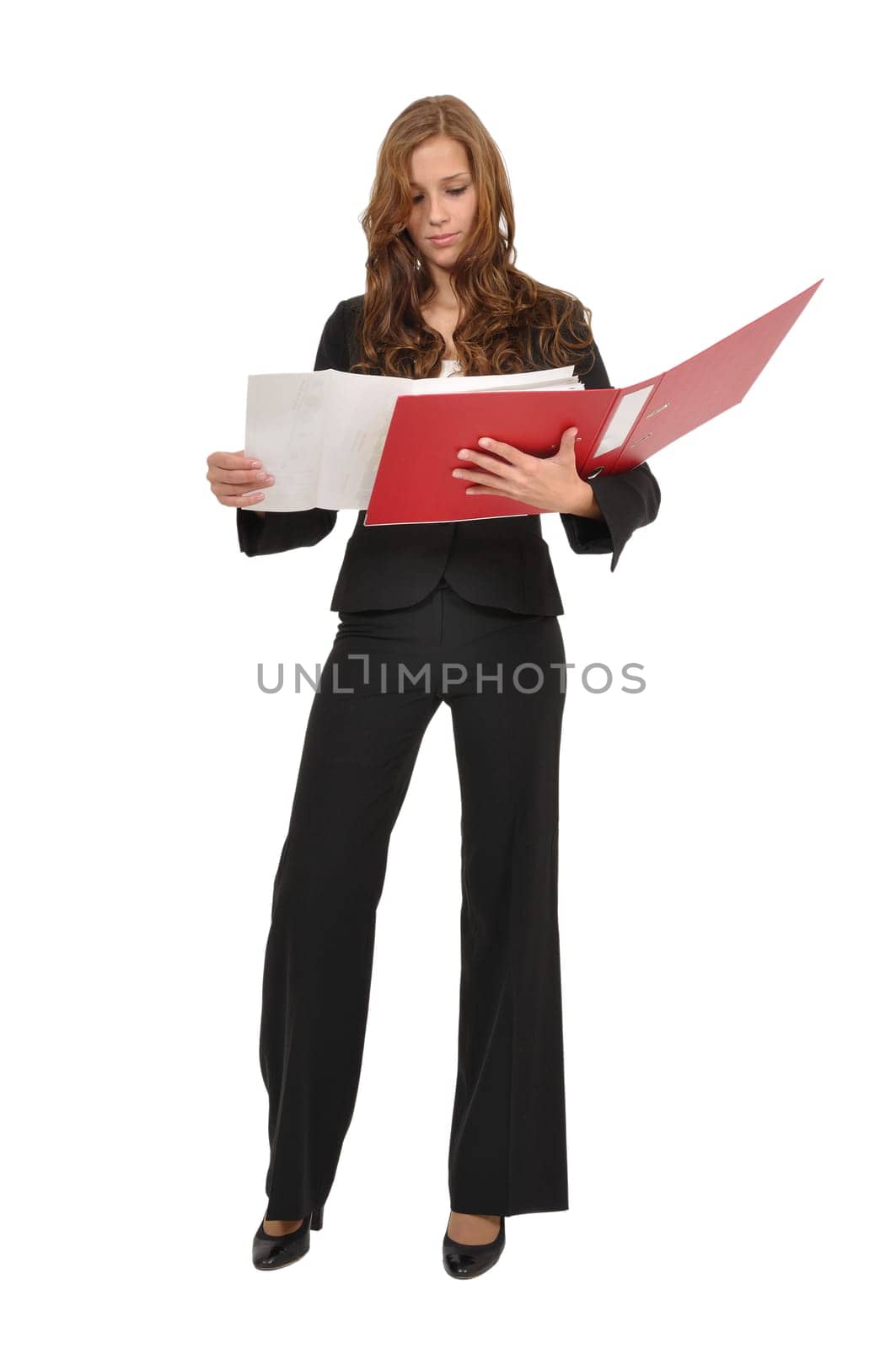 Woman in suit looking at construction drawing in red folder