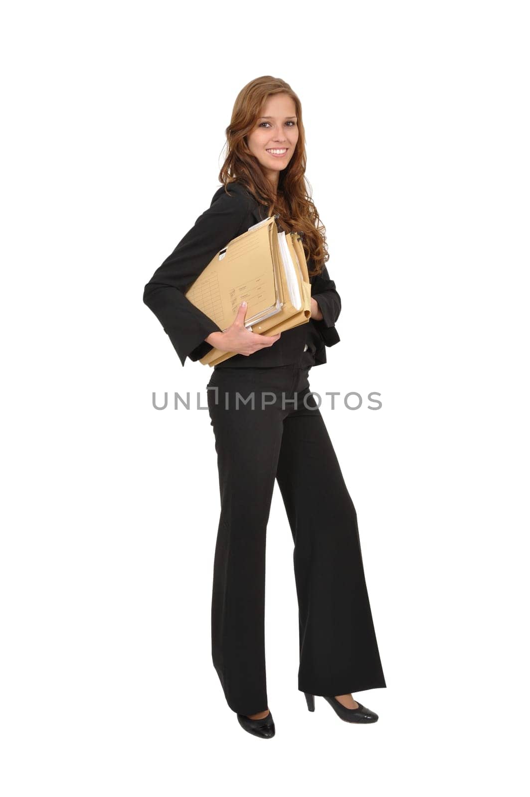 Businesswoman in suit carrying stack of files