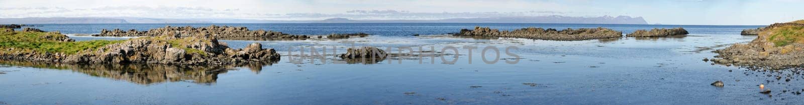 reflected in the sea cliffs of the peninsula in Iceland Vatnsness