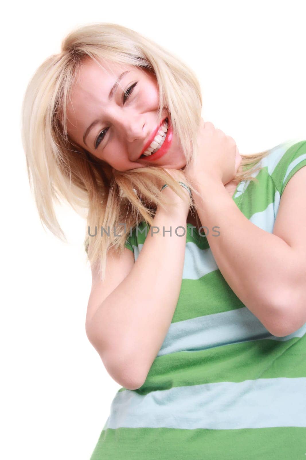 A smiling blonde girl holding her hair