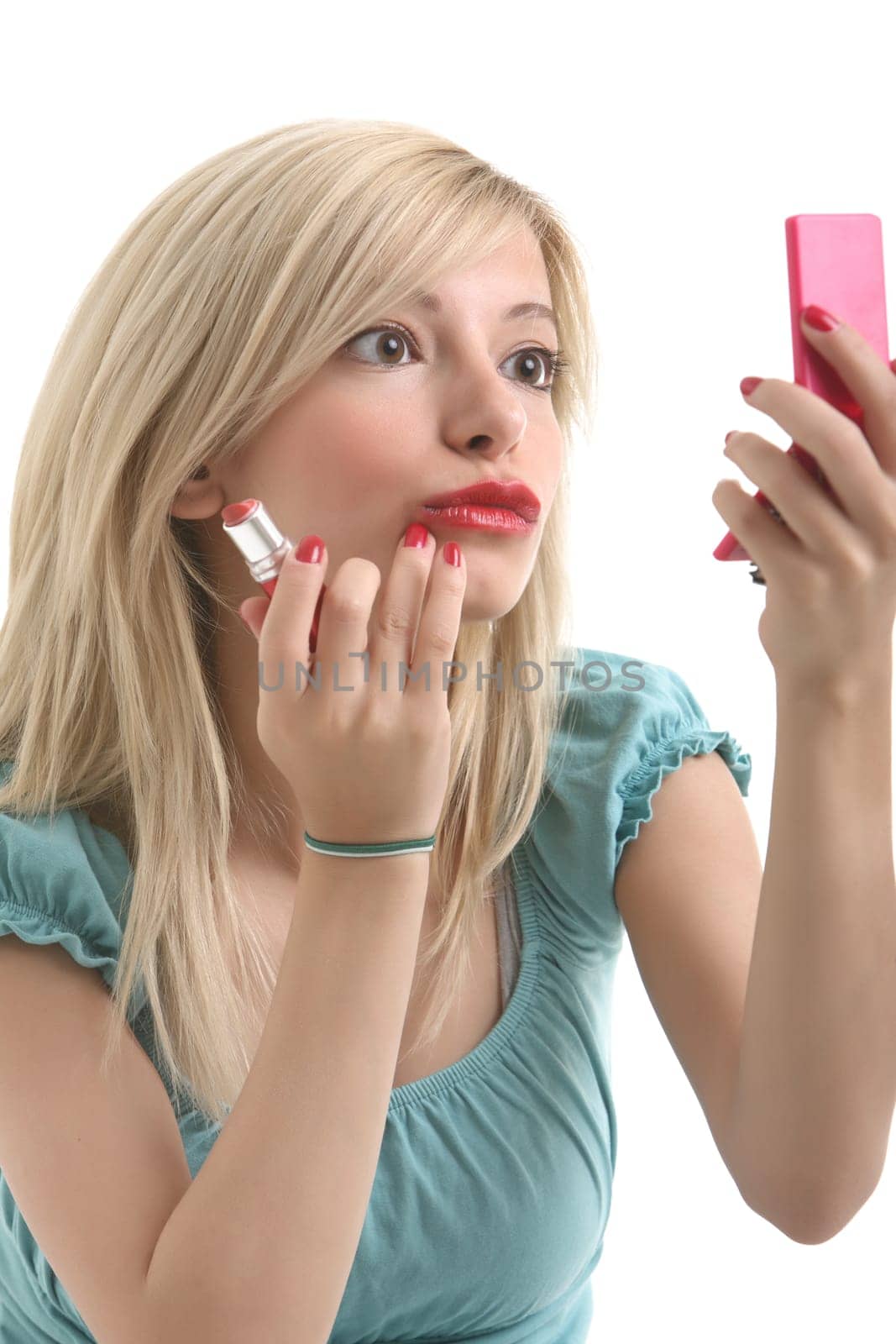 A young blonde doing make up with her small mirror.